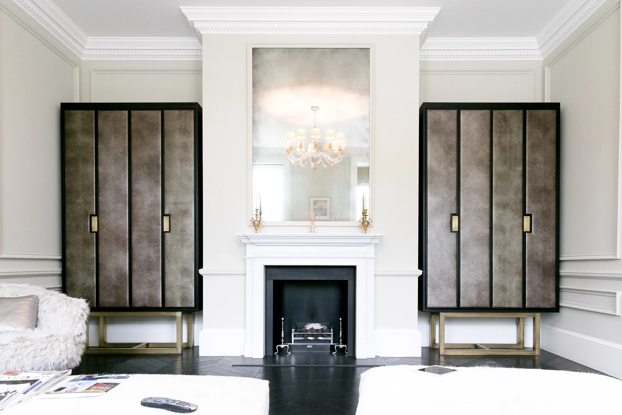 Pair of cabinets framing a fireplace in