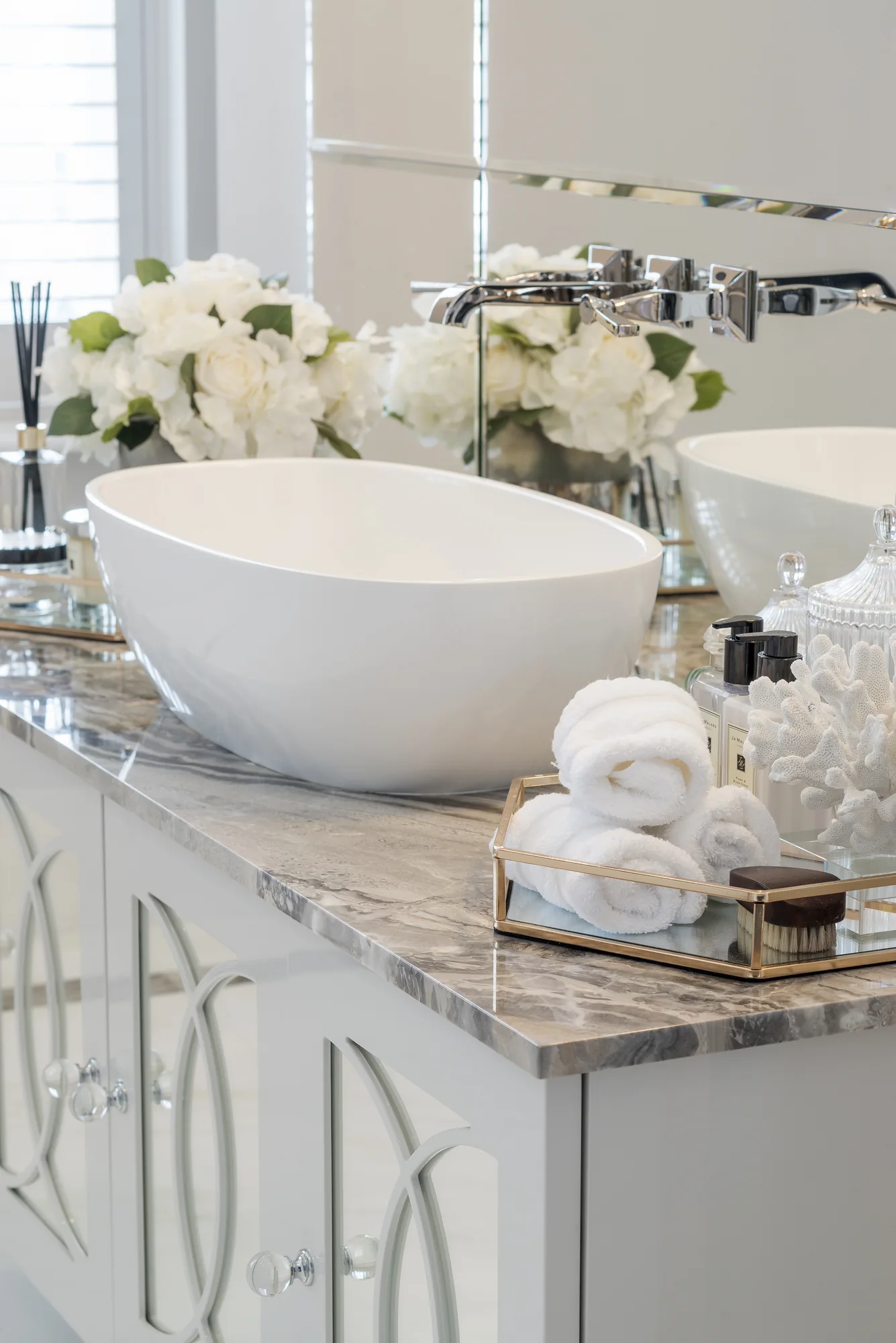 Close view of the bowl basin and decorative vanity door fronts