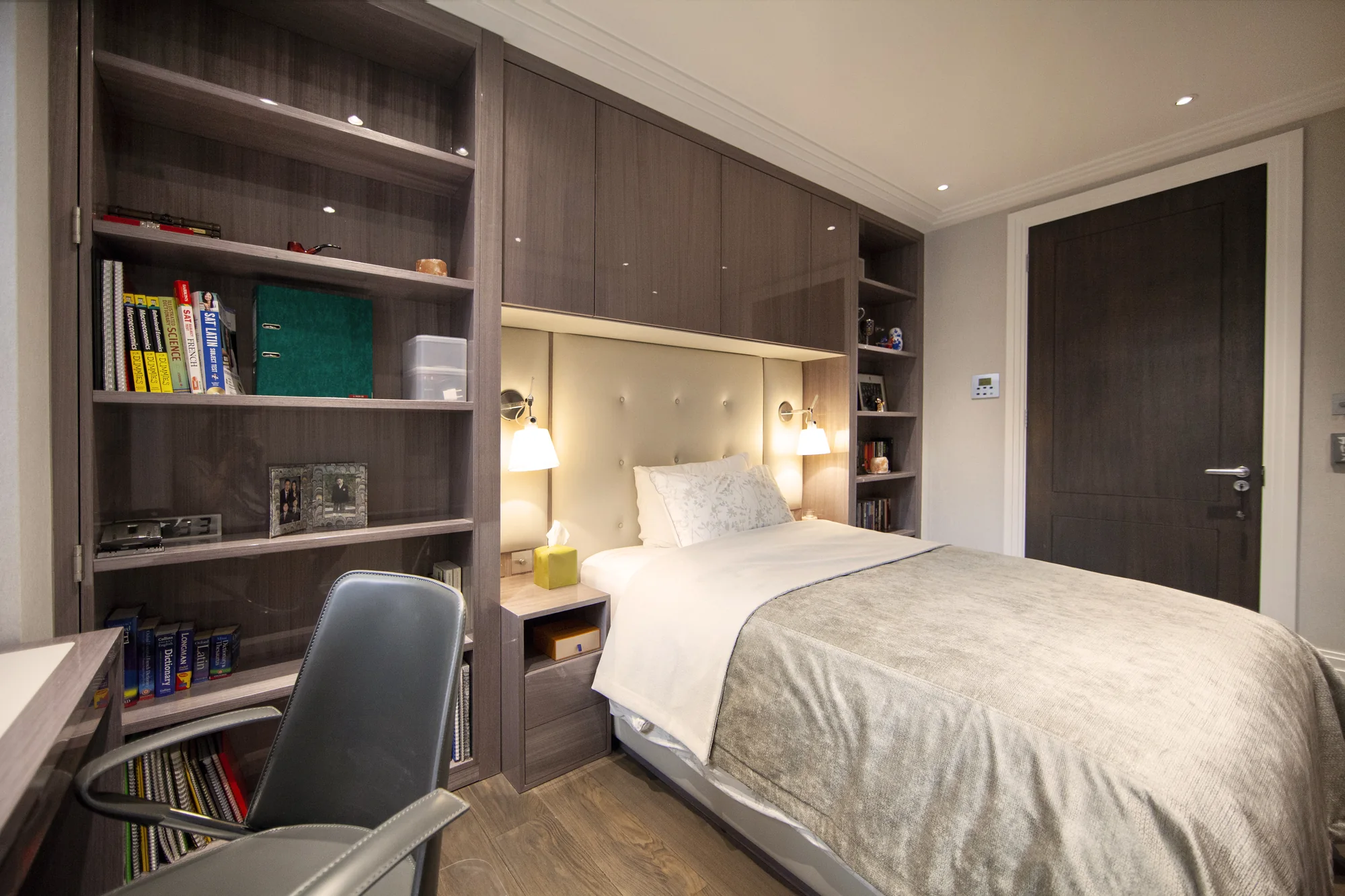 Angled view of the bedroom bookcases and cupboards around the bed