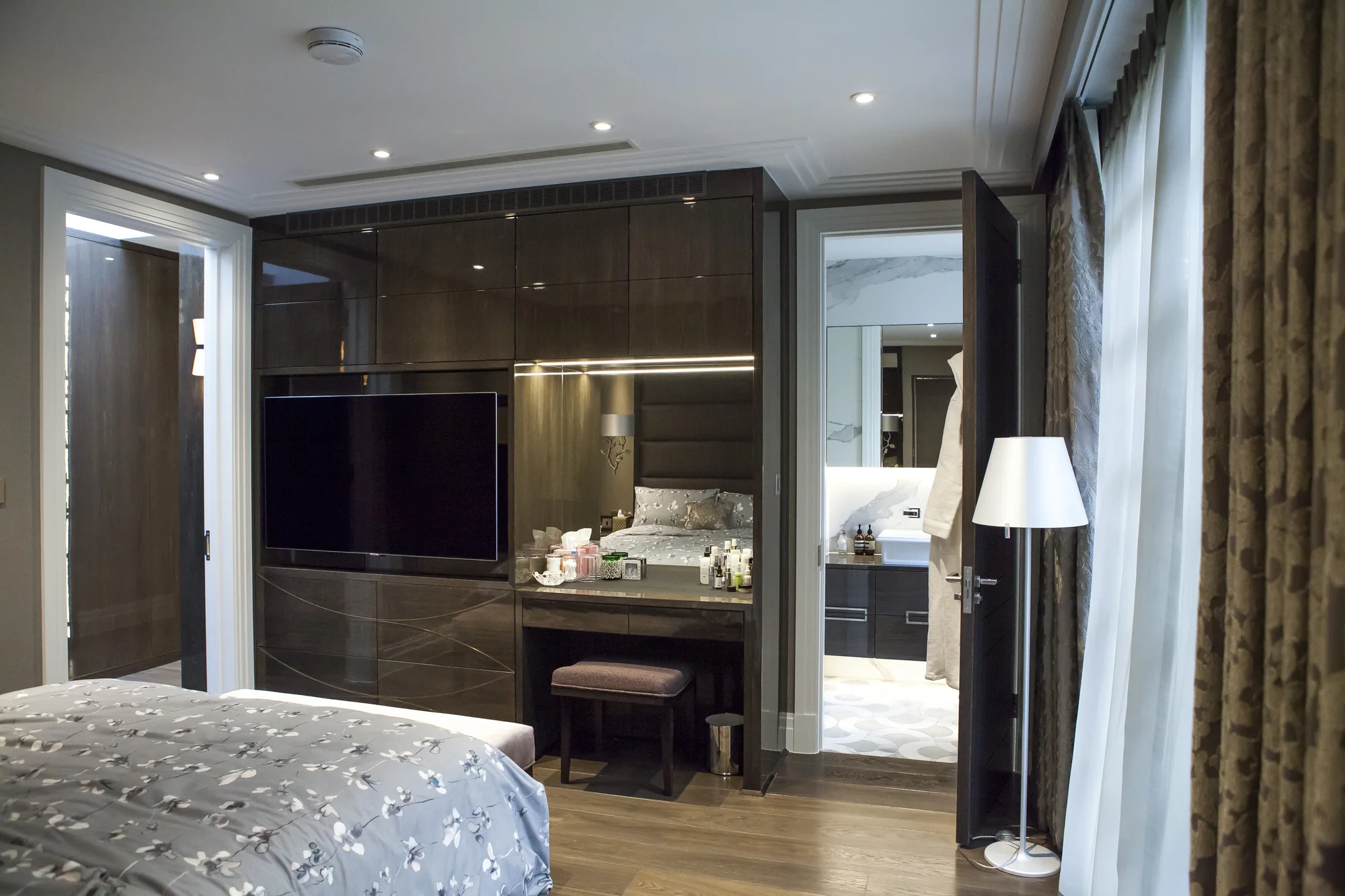 Angled room view of the TV wall and dressing table