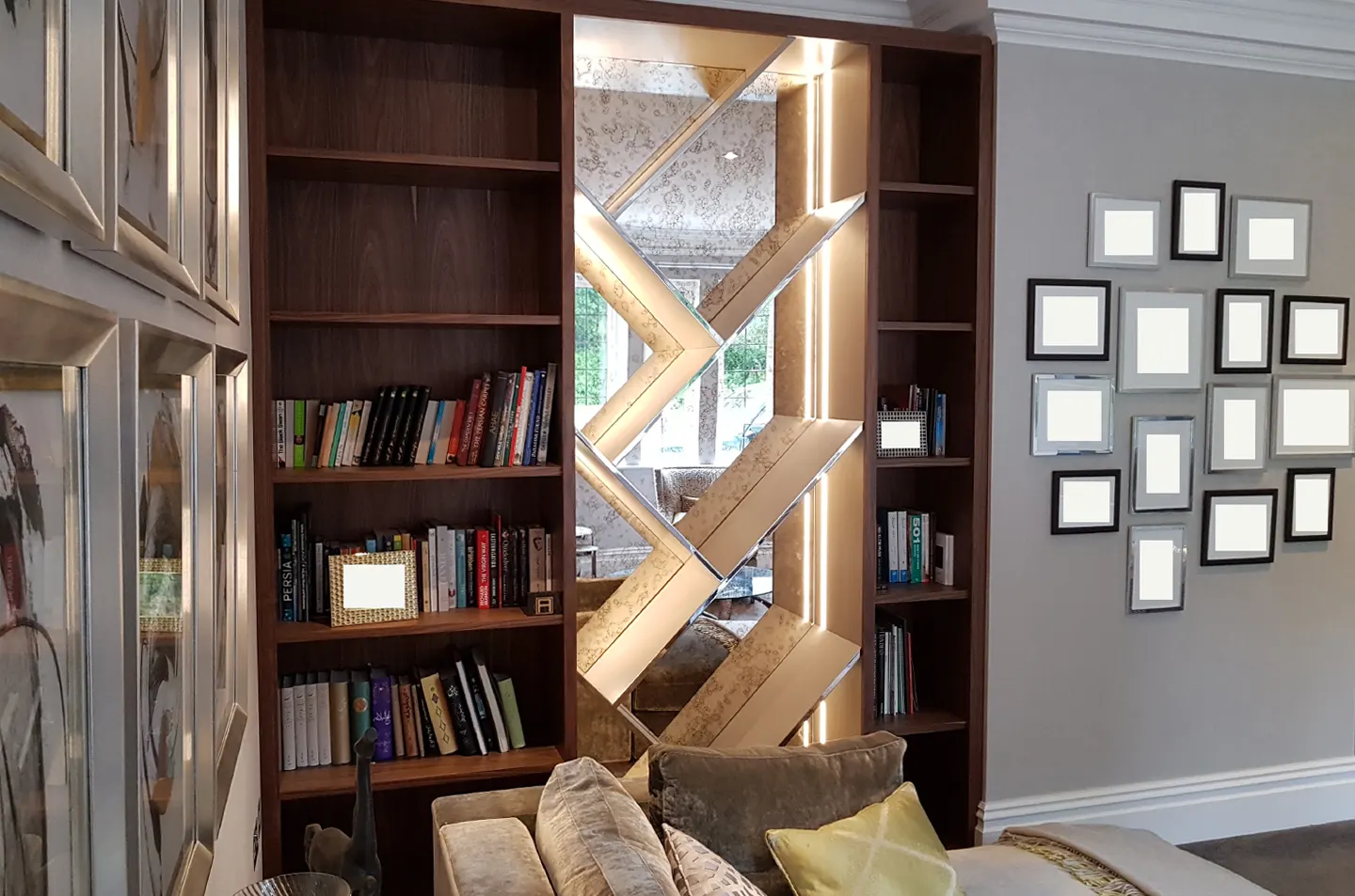 Full view of natural walnut shelving with geometric illuminated mirror feature