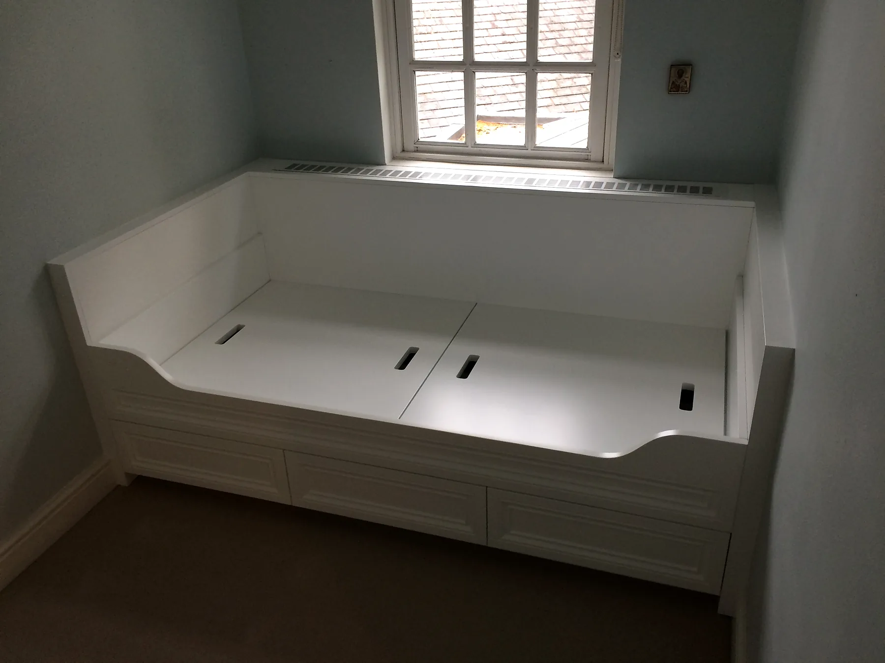 Painted built-in window seat with drawer storage