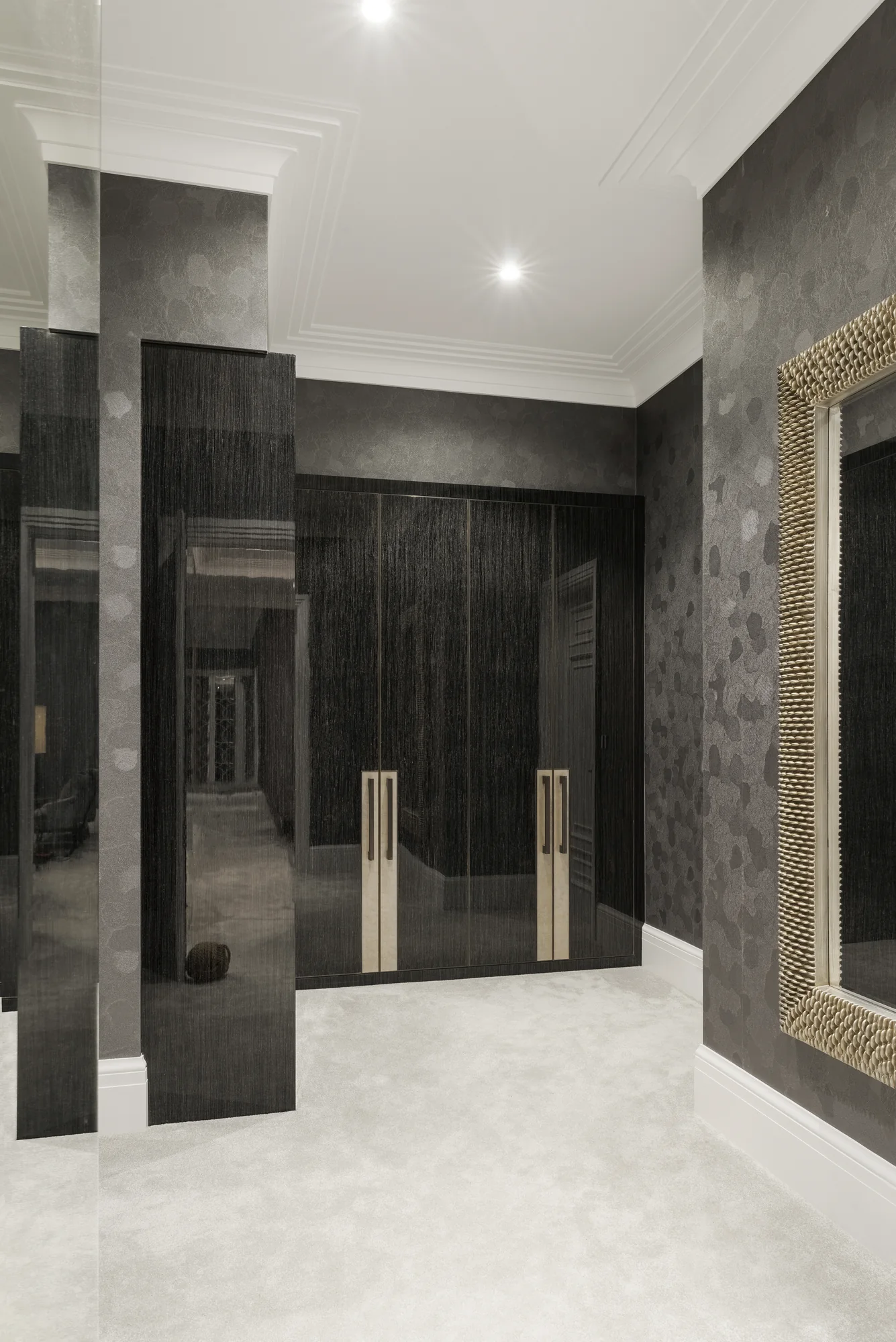 Overall view of the dark fitted walk-in wardrobe at the residence