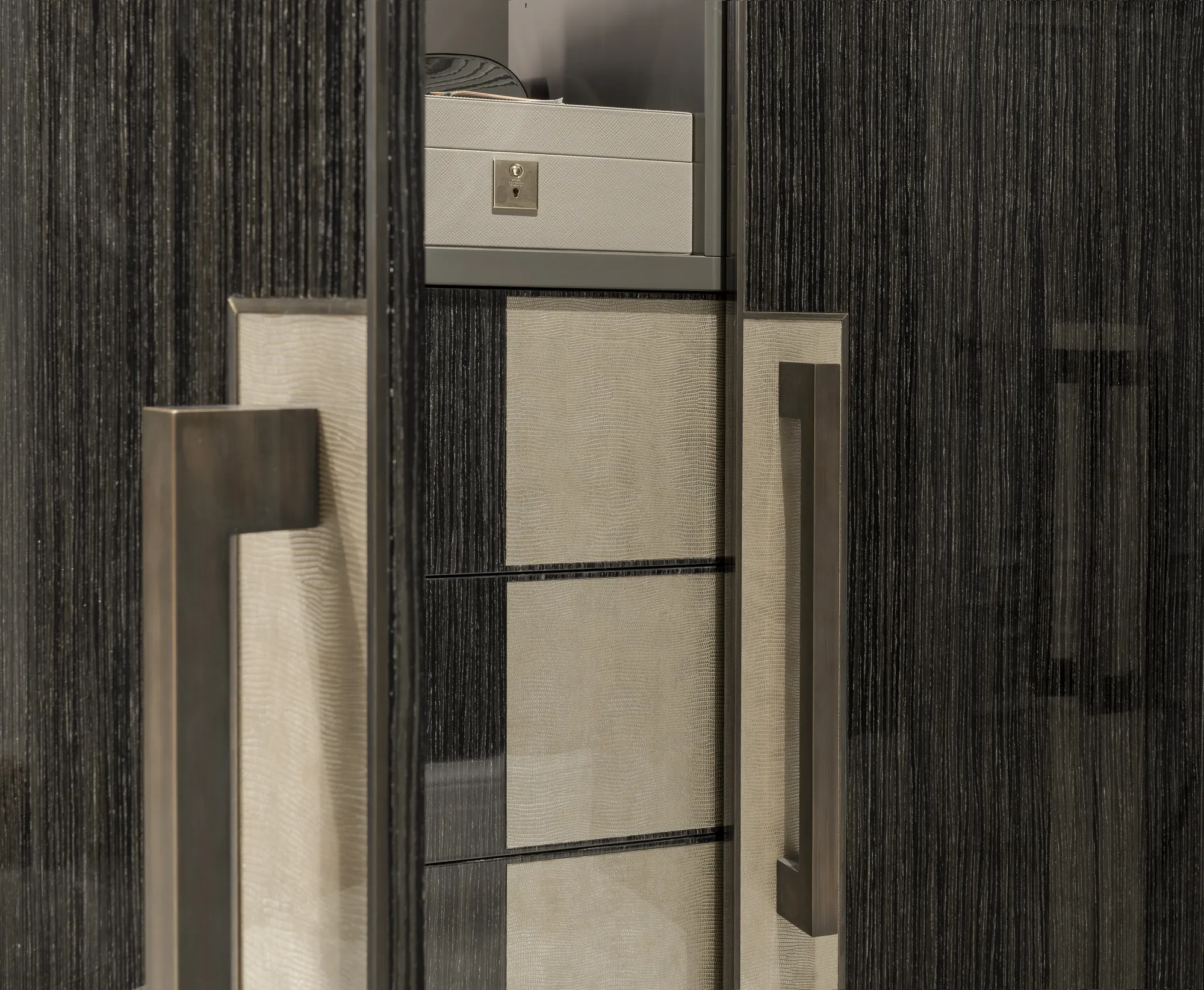 Metallic fitting detail on the dark wardrobe cabinetry
