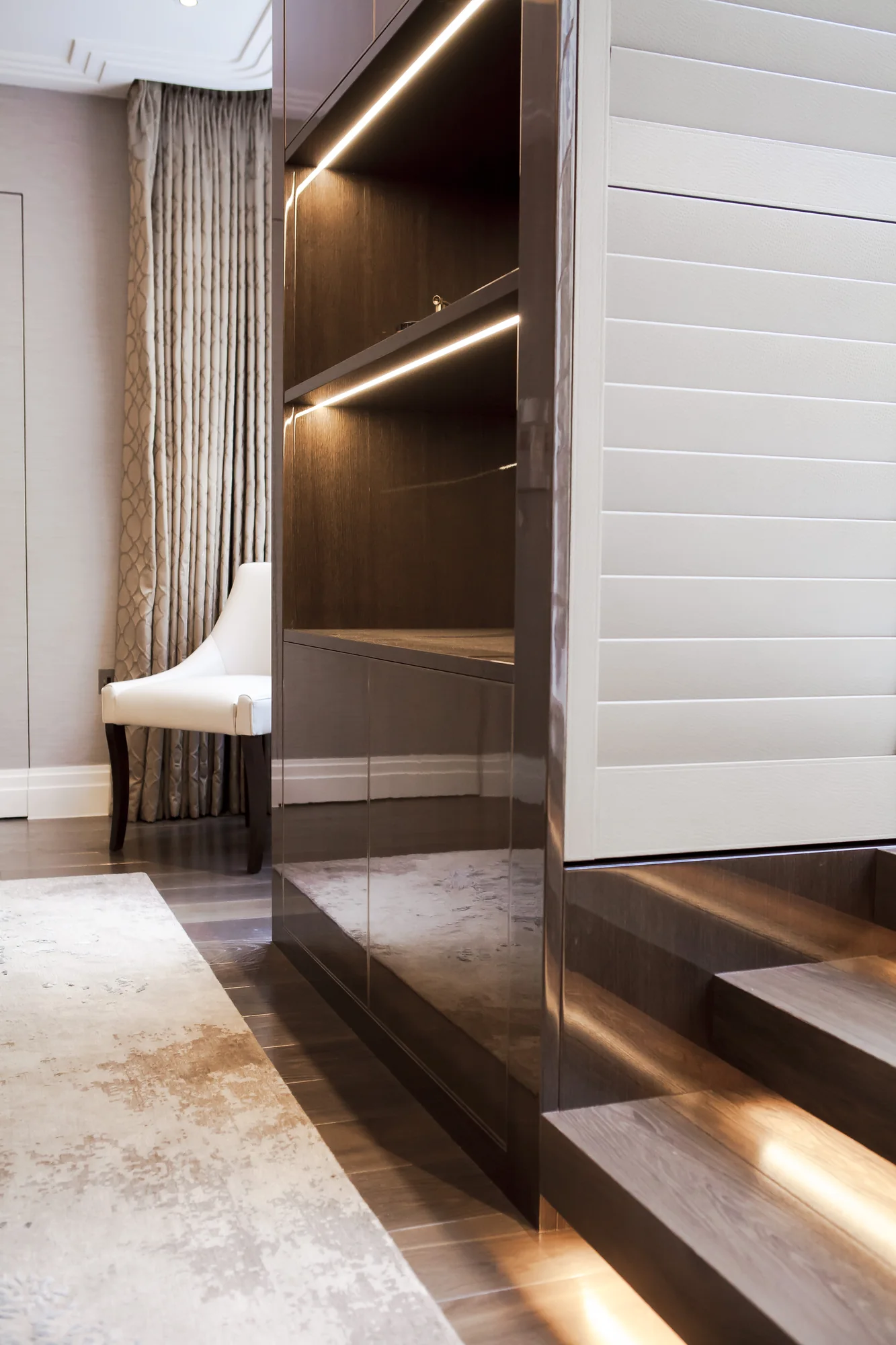 Illuminated dining display shelves beside the window shutters