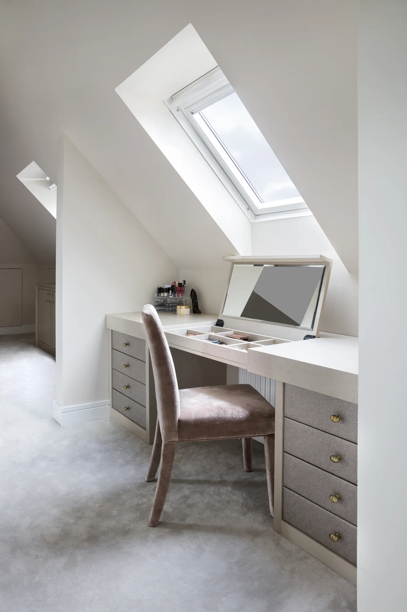 Side view of the fitted dressing table and chair under the sloping ceiling