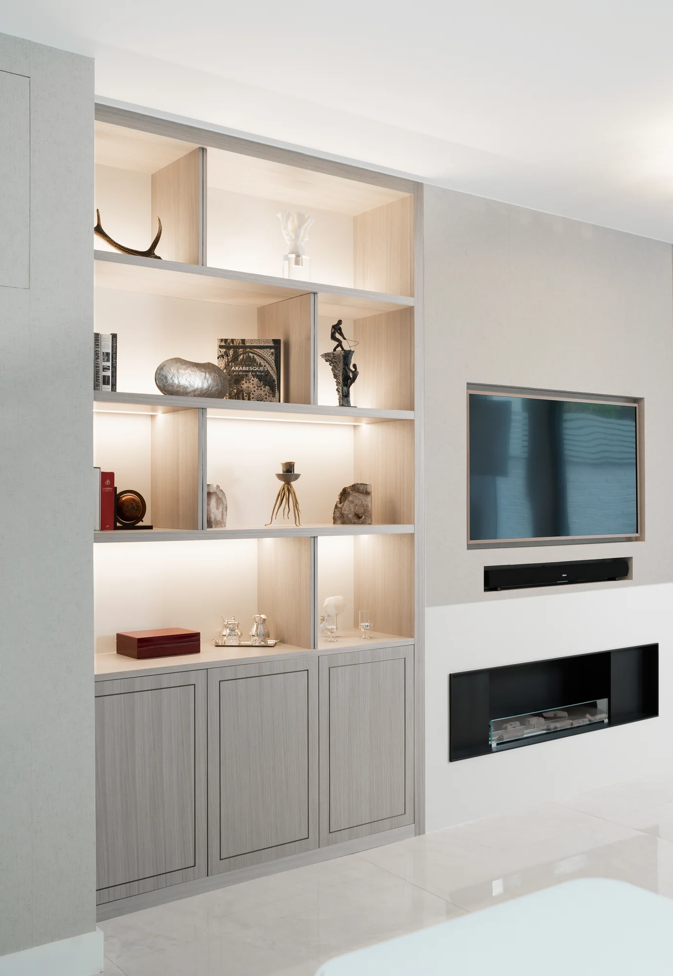 Left alcove display unit viewed beside the television, recessed speaker and fireplace