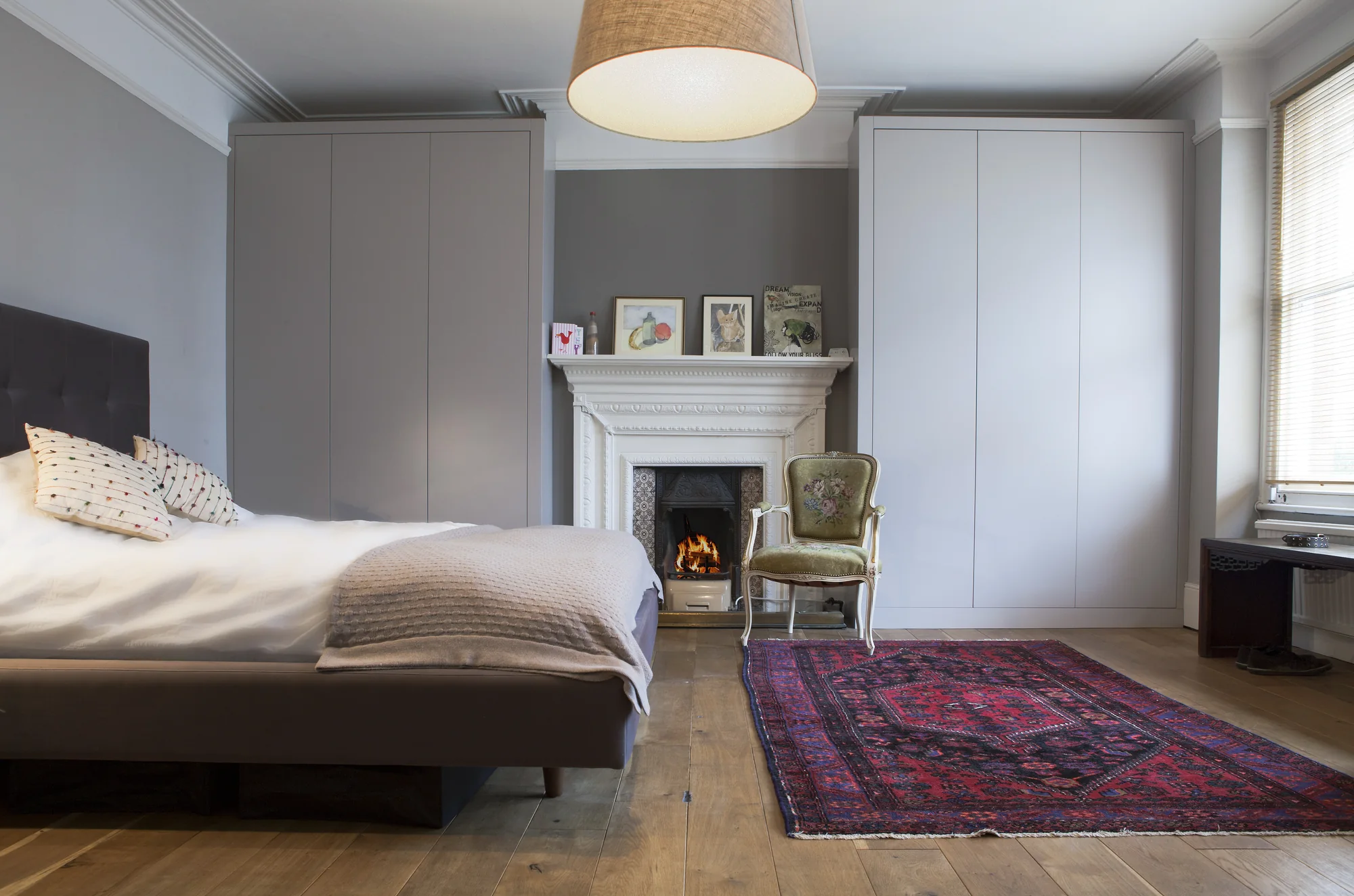 Closed view of fitted wardrobes around the fireplace