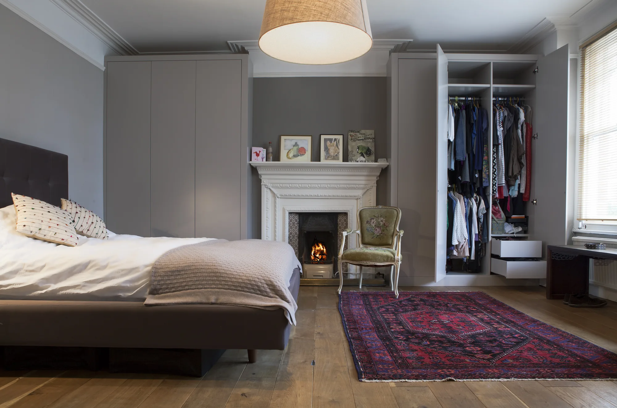 Open fitted wardrobe showing hanging and drawer storage