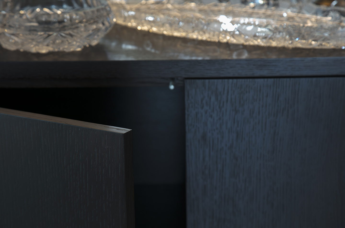 Open lower bookcase door showing the dark grain and cabinet edge