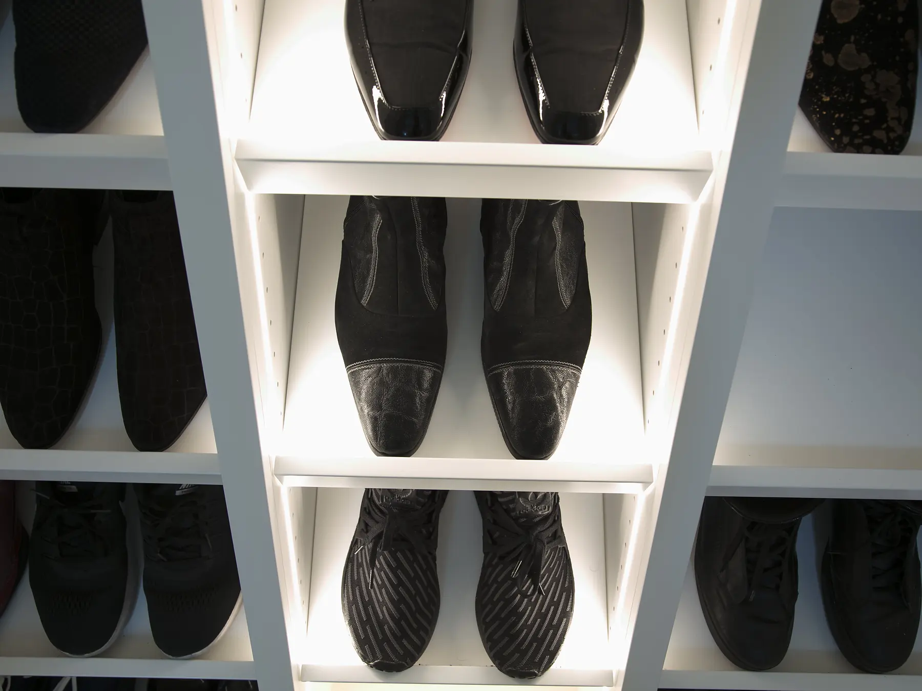 Illuminated centre shelving detail in shoe-storage cabinet