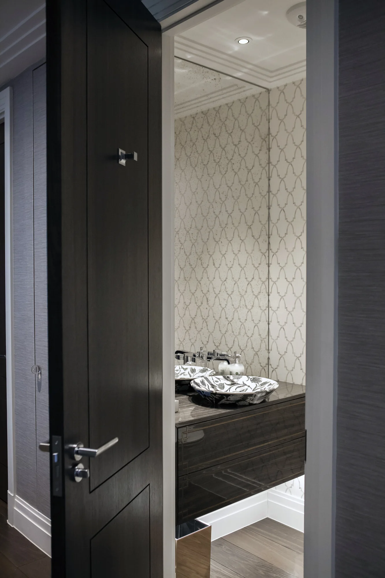 Doorway view of the dark cloakroom vanity and decorative basin