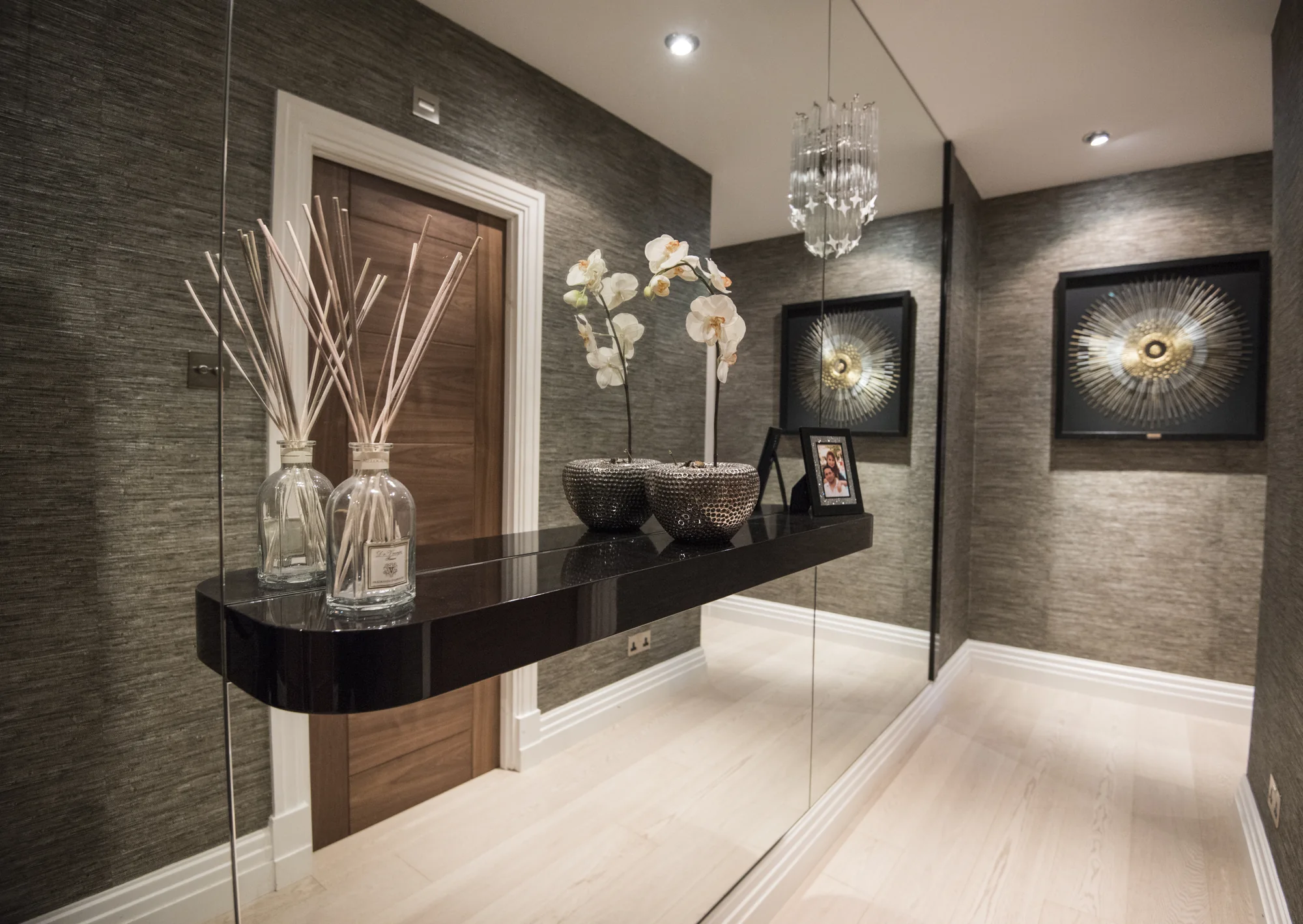 Floating display shelf and mirrored wall feature in