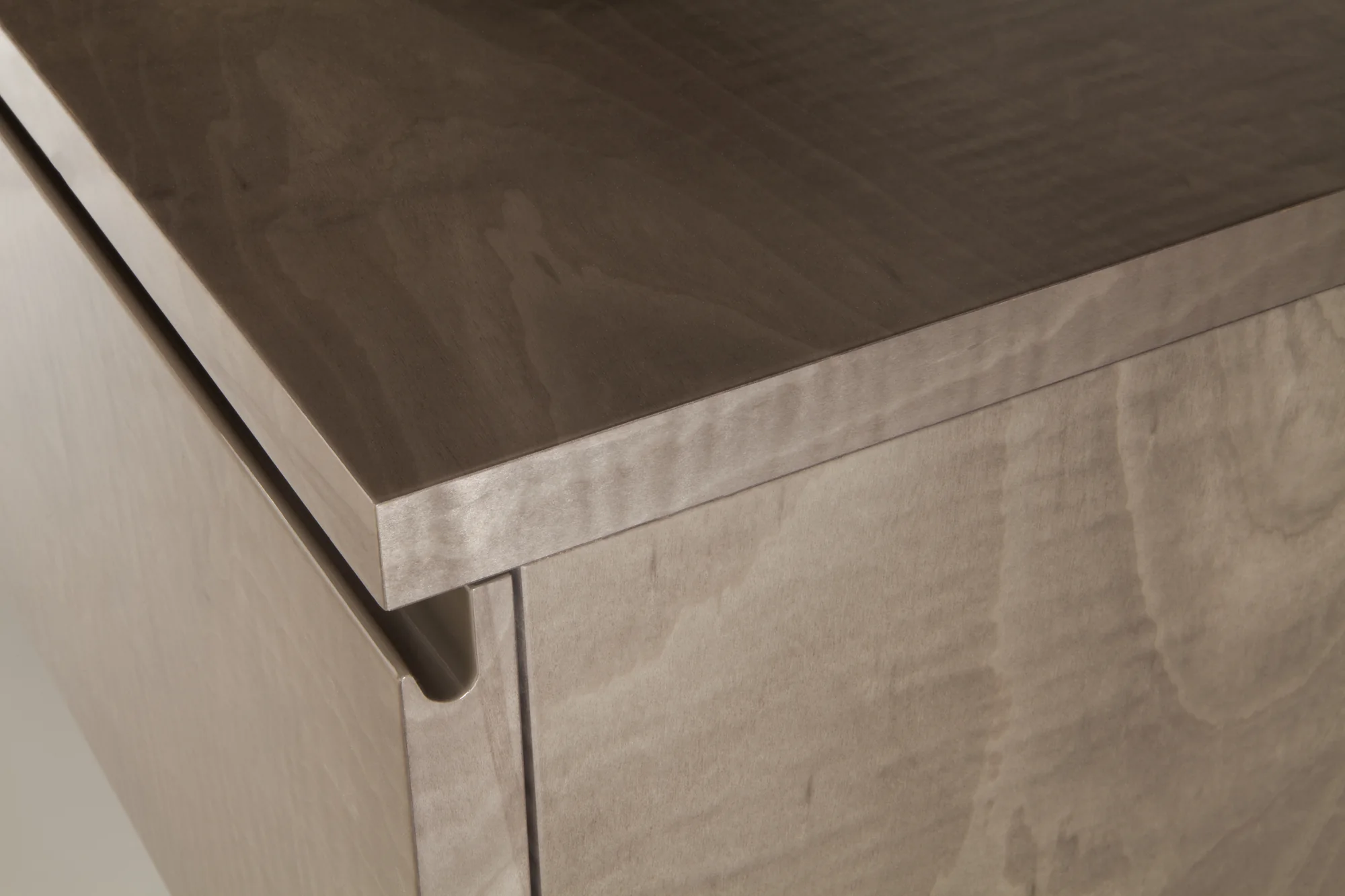 Close finish detail on light grey media cabinetry