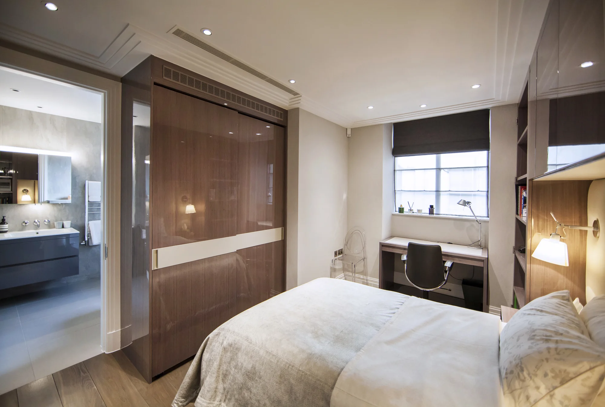 Closed glossy bedroom wardrobe doors with a contrasting pale horizontal band