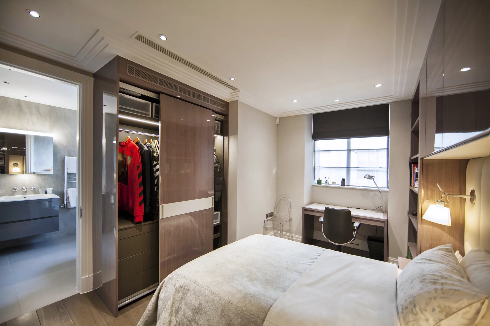 Open fitted wardrobe beside the bedroom doorway