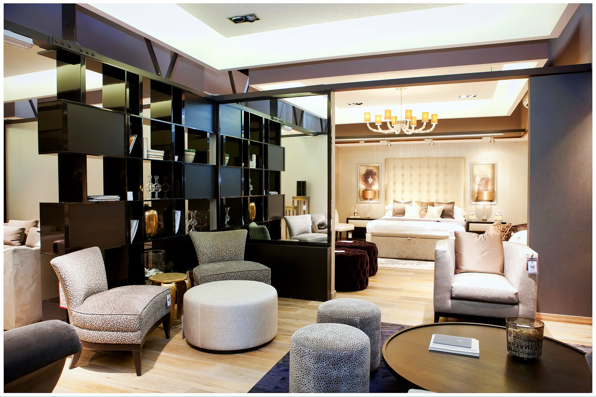 Dark high-gloss bookcase forming an open room divider