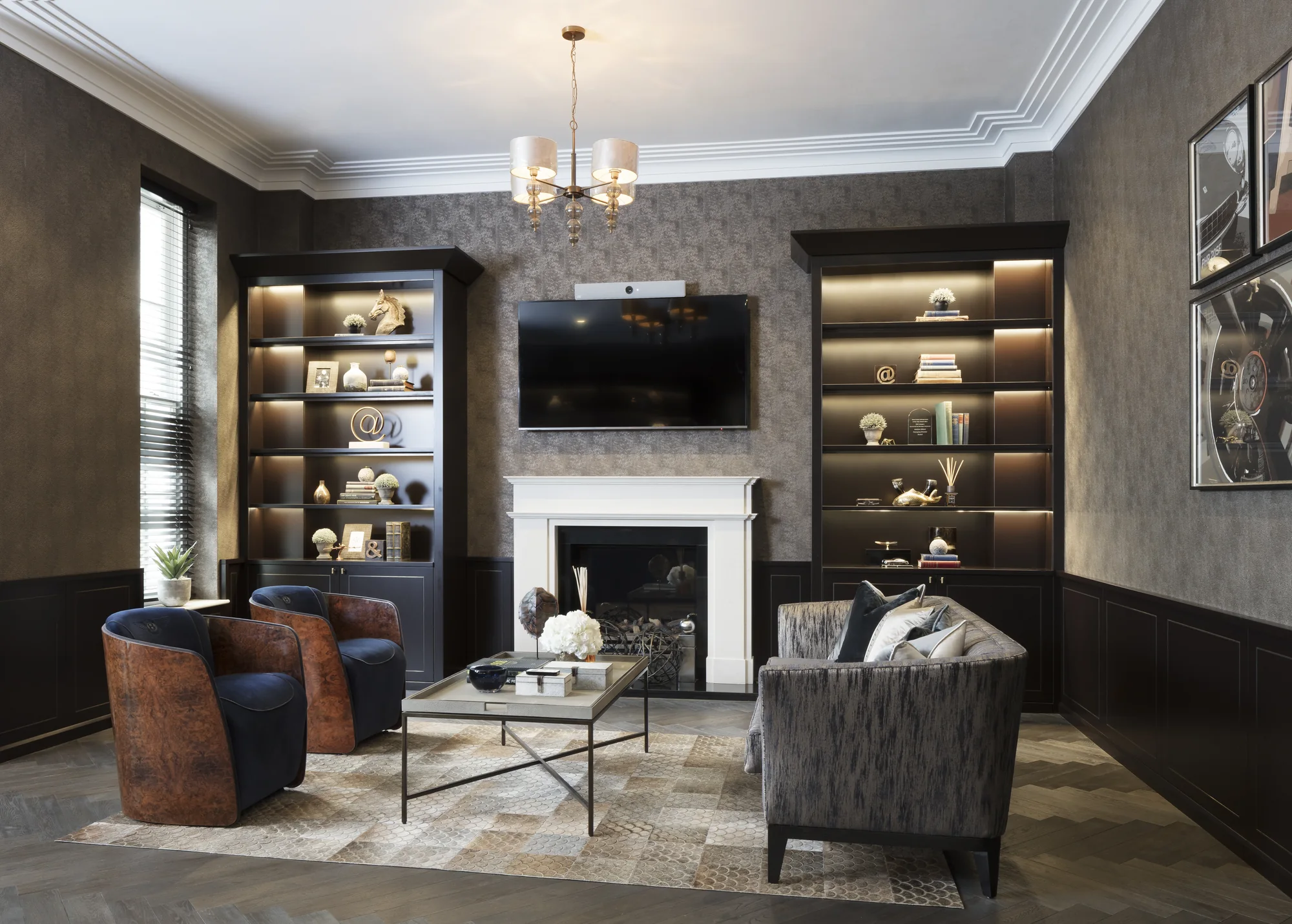 Home-office seating area with illuminated alcoves beside the television and fireplace