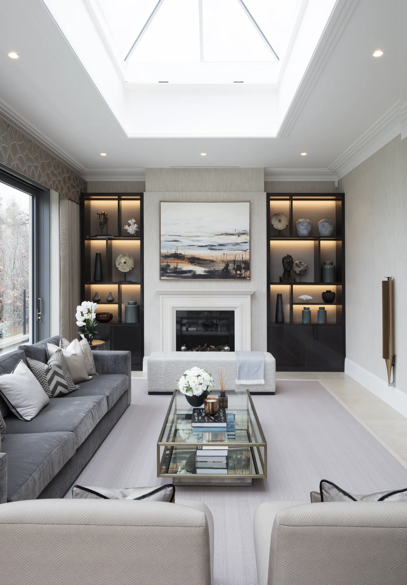Full view of the illuminated alcove pair beside the fireplace in the rooflit living room