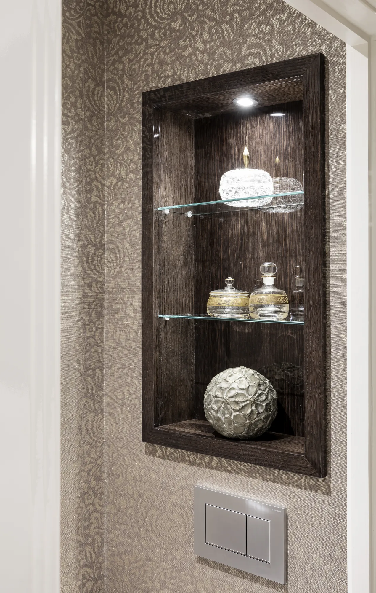 Recessed illuminated display niche with fitted shelving