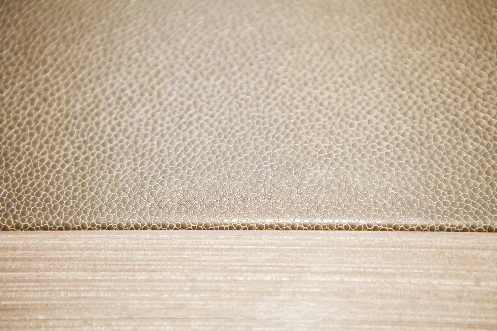 Textured inset work surface meeting the pale desk border