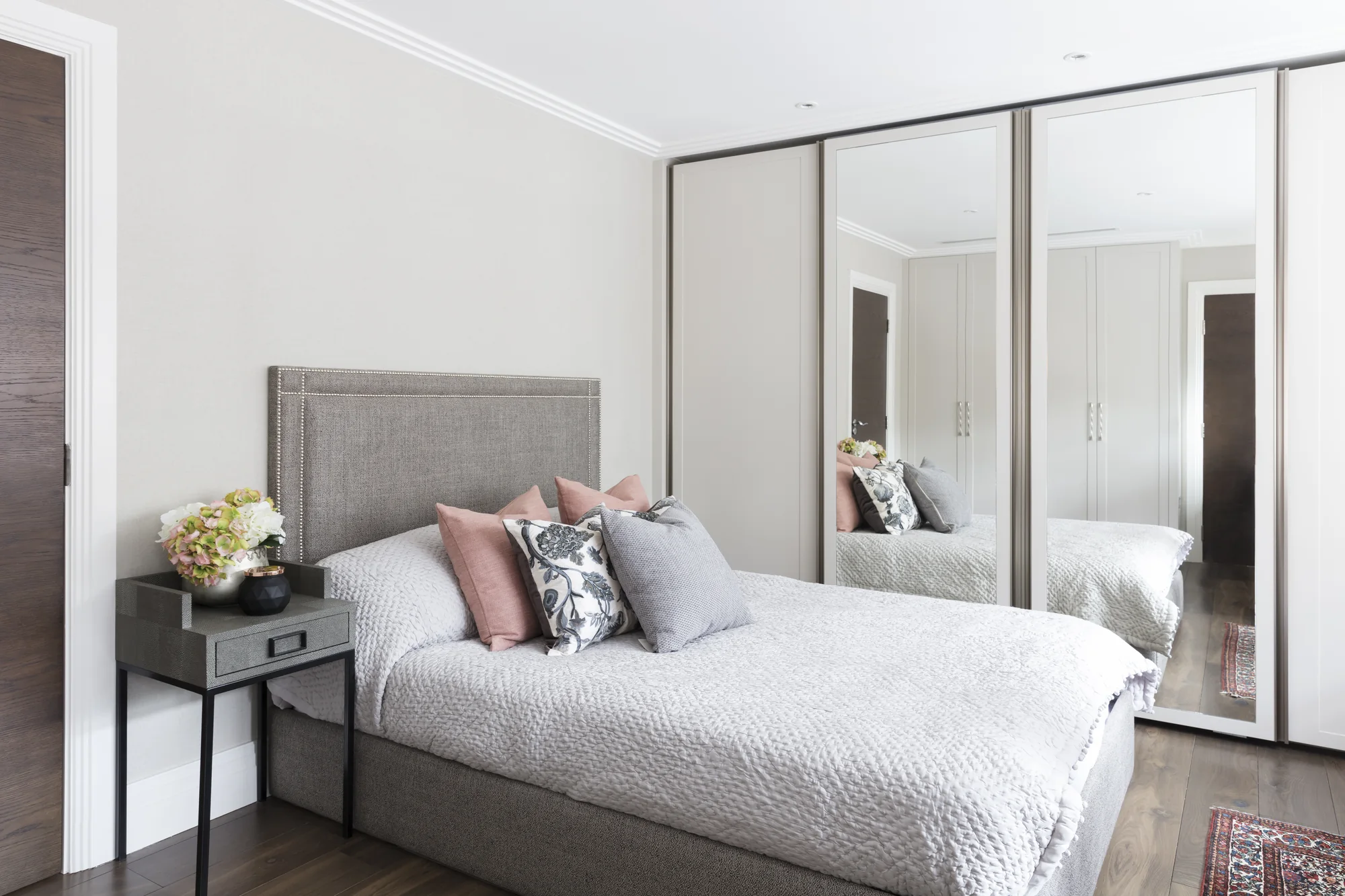 Overall view of full-height mirrored wardrobes