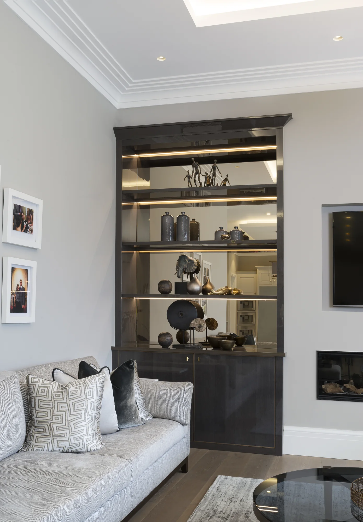 Left-hand modern alcove with reflective shelves and projecting top detail
