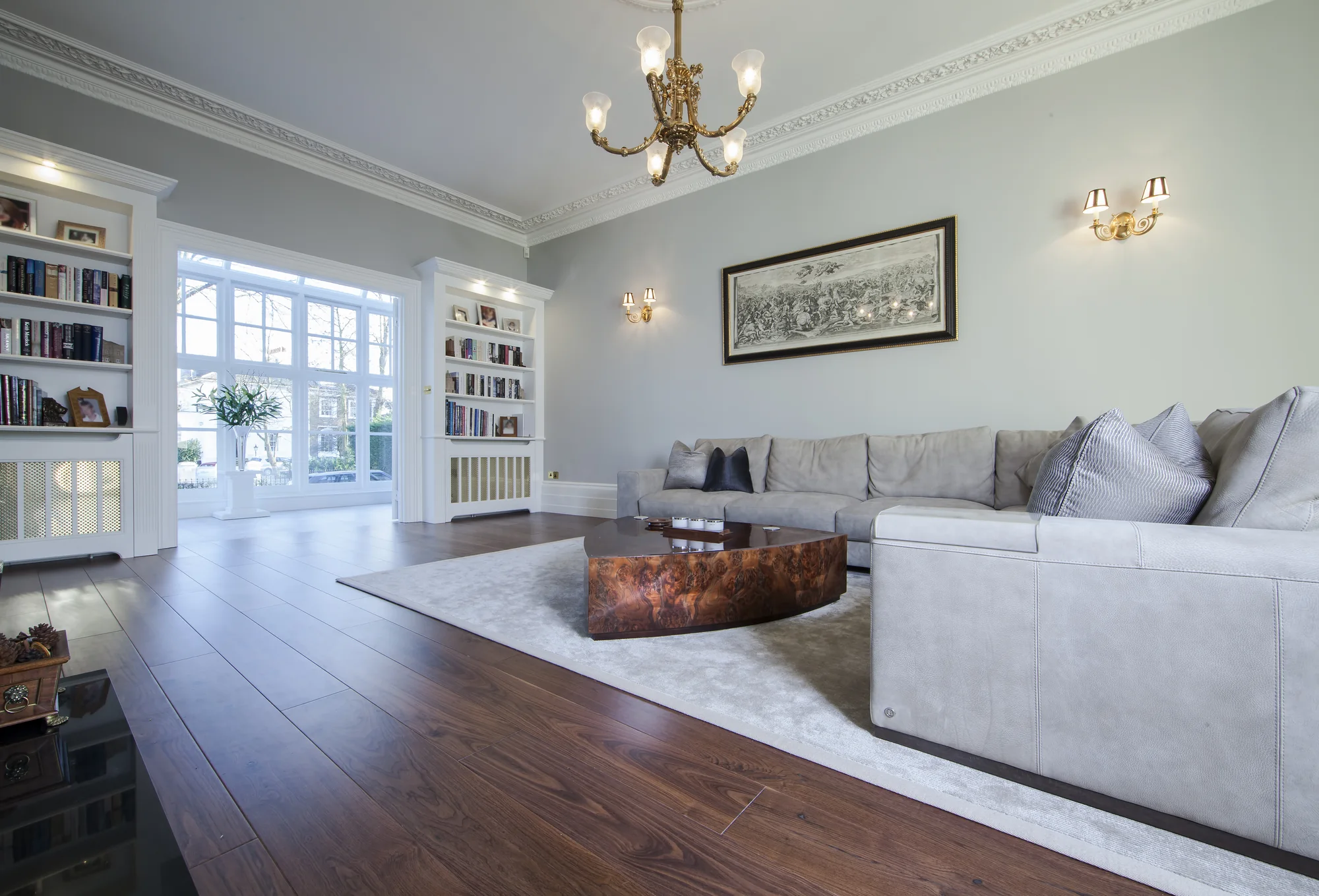 Sitting-room view with white fitted shelving and radiator-cover joinery