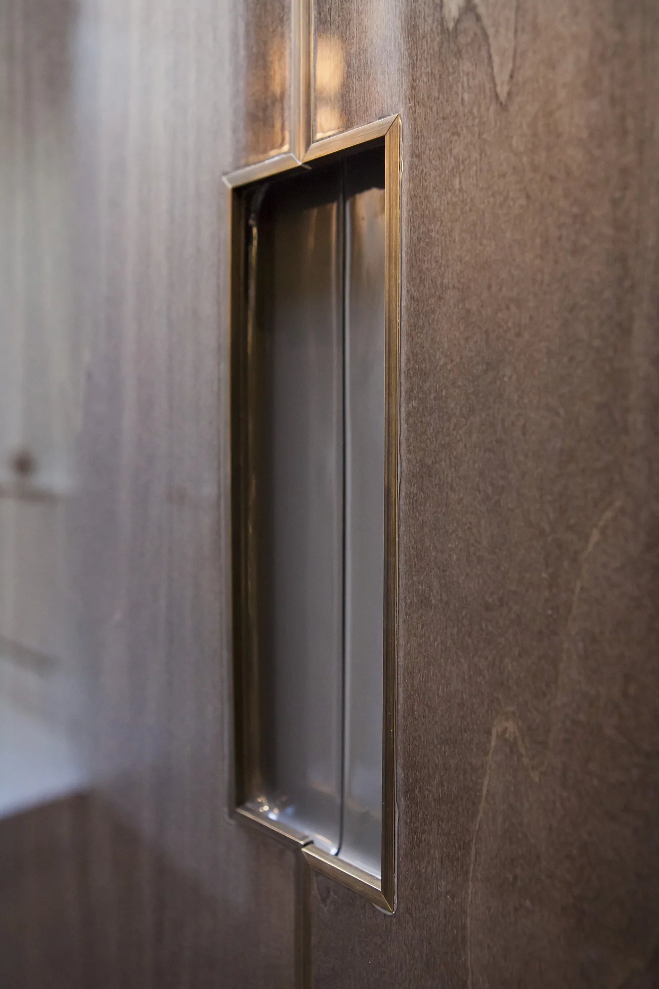Shaped metallic inset detail within the wardrobe frontage