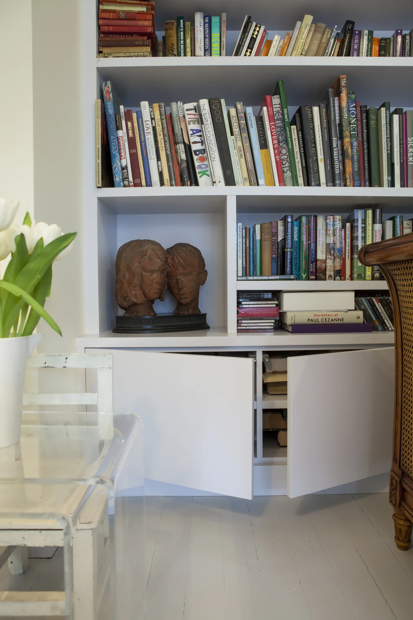 Open lower storage compartments beneath the library shelves