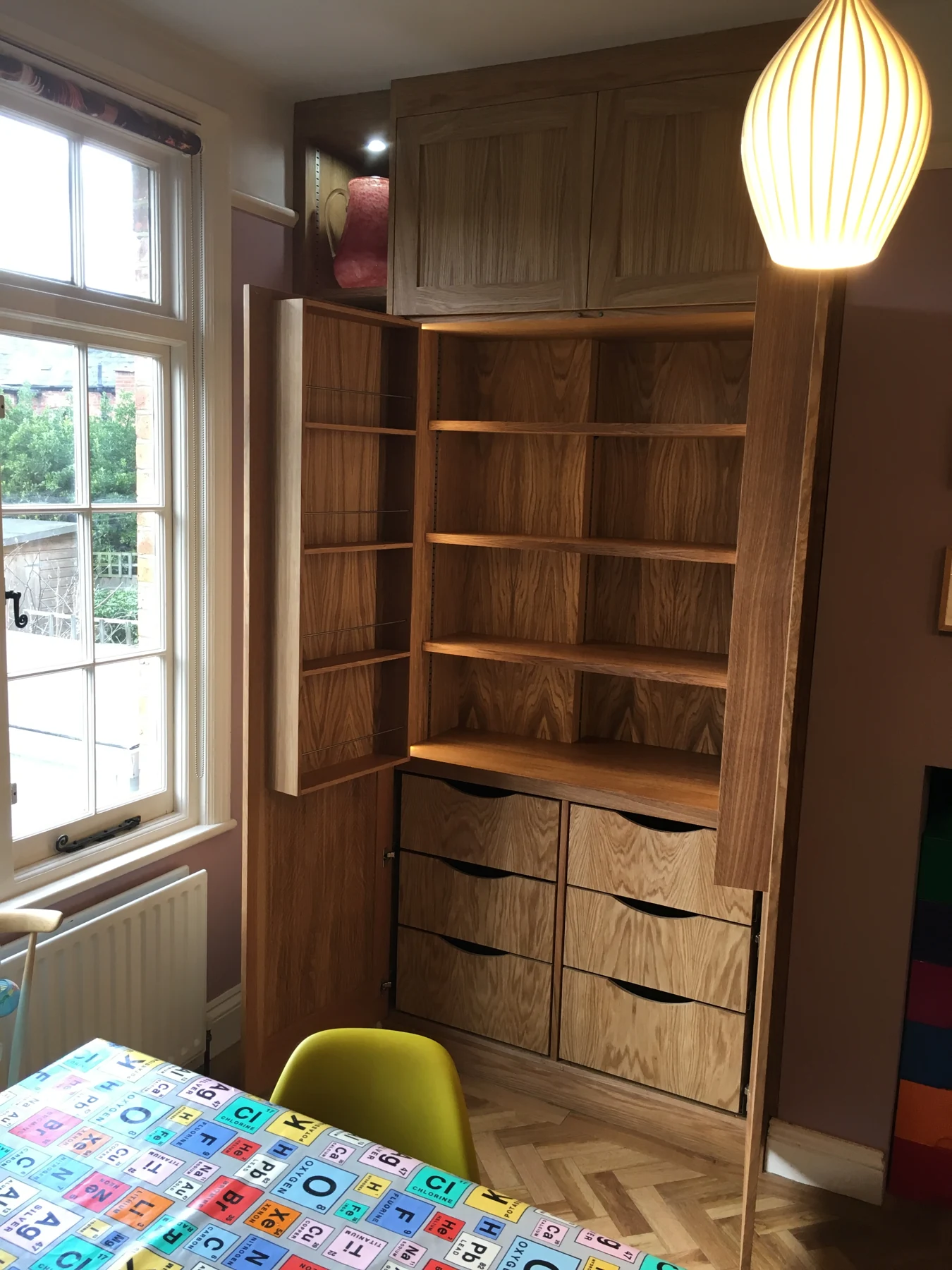 Matching wood-grain storage with open shelving and internal drawers exposed.